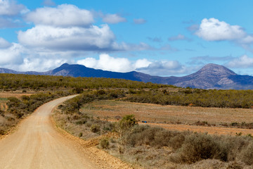 Fototapeta premium The Long dirt road to the mountains