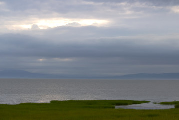 Coastline on a very cloudy day with a ray of sunshine