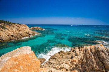 Cliff near Chia beach with azure water, Sardinia, Italy