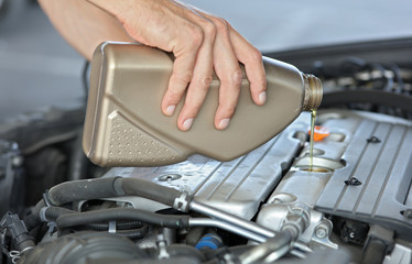 Adding car engine, motor oil level.