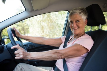 Active senior woman driving a car