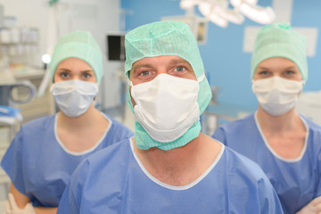 three surgeons in surgical theatre