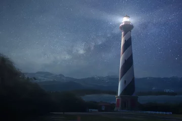 Fototapeten A lighthouse under night sky © Kevin Carden