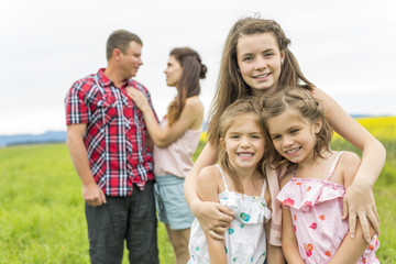 Family outdoors on a yellow field