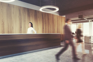Wood reception in round lamp office, side view men