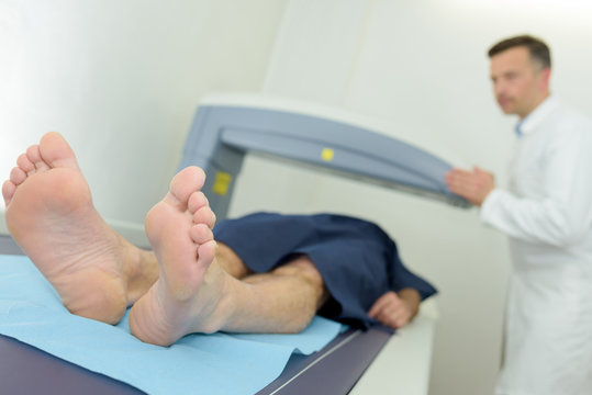 man going through ct scan in hospital