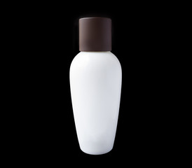 White and brown bottle of perfume spraying, isolated on black background
