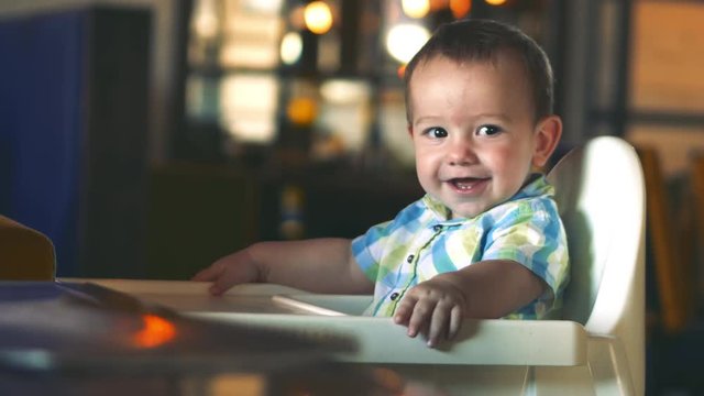 Charming child laughs and claps his hands. 4k.