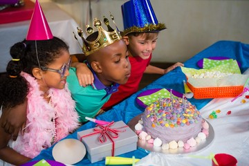 Boy blowing candles on cake