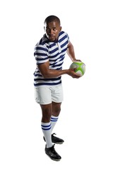 Full length of male rugby player throwing ball