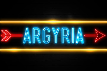 Fototapeta premium Argyria - fluorescent Neon Sign on brickwall Front view