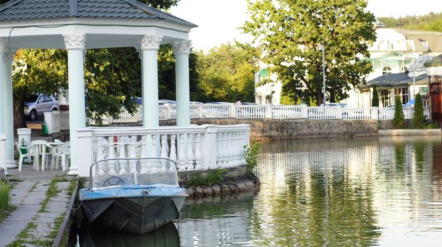 Motor boat at the pier on the lake in the city park of Nalchik.