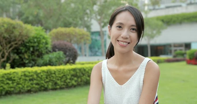 Asian woman smile to camera in Hong Kong city