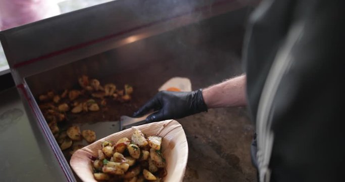 Food Truck owner plating up a dish
