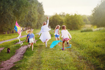 happy children in summer nature, flying a kite