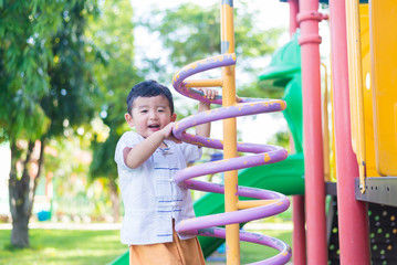 Obraz premium Active little child playing climbing spring metal at school yard playground.