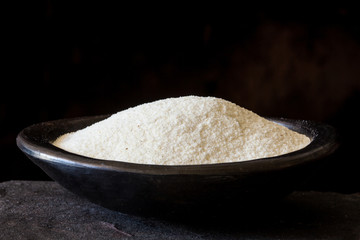 Maize flour (Zea mays)  in a traditional black clay dish