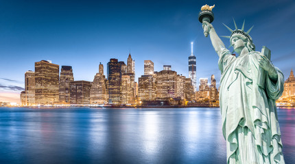 The Statue of Liberty with Lower Manhattan background in the evening, Landmarks of New York City, USA