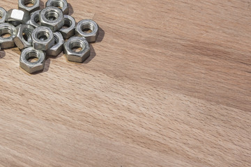 metal nuts on a wood background