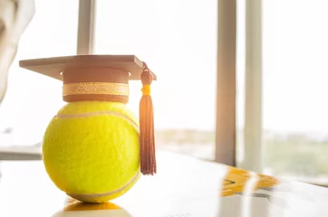 Foto op Canvas Graduation cap Put on Ball with clock, Tennis is a racket sport can be played individually against single opponent, Sports competition success concept © smolaw11