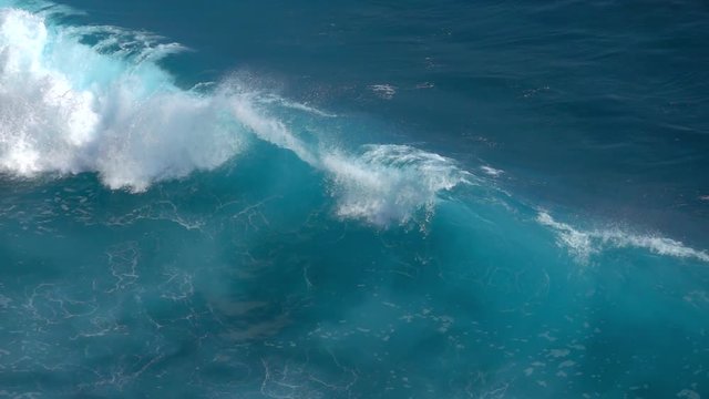 SLOW MOTION, CLOSE UP: Huge turbulent foamy ocean wave rising and breaking. Perfect barrel wave rolling upon the shore splashing. Big tube wave crushing, sea waterdrops spraying and sparkling in sun