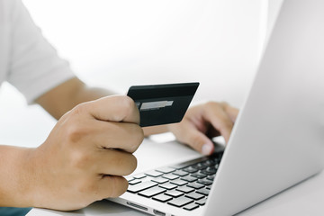 Businessman doing online shopping Hand holding credit card and using laptop. Online shopping concept