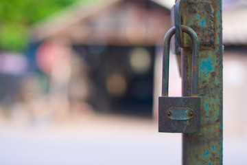 The steel door with an unlocked lock,Old master key is lock on the steel door of factory.