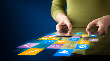 Hand holding tablet device with media application