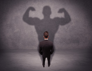 Successful businessman with strong shadow