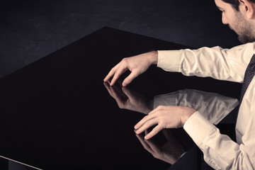 Close up of a hand touching smart table with copy space