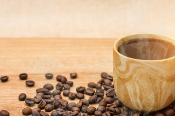 Coffee espresso and coffee cup and beans on table,Tea cup on table,warm cup of coffee on brown background,