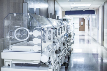 Newborn infant incubator boxes in a hospital corridor  - obrazy, fototapety, plakaty