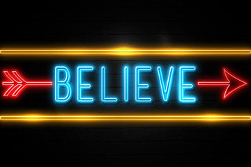 Obraz premium Believe - fluorescent Neon Sign on brickwall Front view