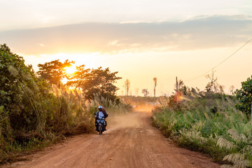 Fototapeta premium Red ground and dust on the rural road in Cambodia