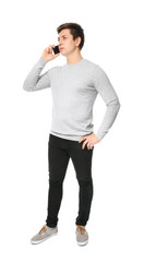 Cute teenage boy with mobile phone on white background