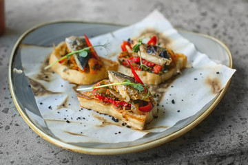 Delicious molletes with fillet of fish and vegetables on plate