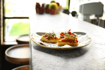 Delicious molletes with fillet of fish and vegetables on plate