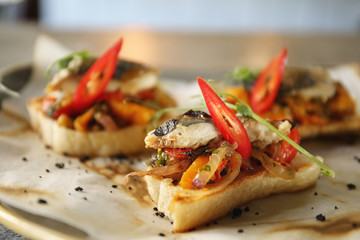 Delicious molletes with fillet of fish and vegetables on plate