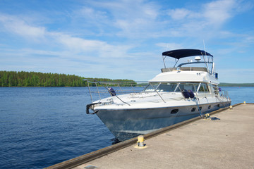 Fototapeta na wymiar A modern boat at the pier on the Saimaa lake