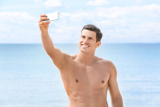 Handsome Young Man Taking Selfie On Sea Beach