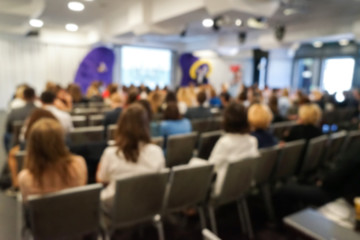 Blurred business people sitting in conference hall