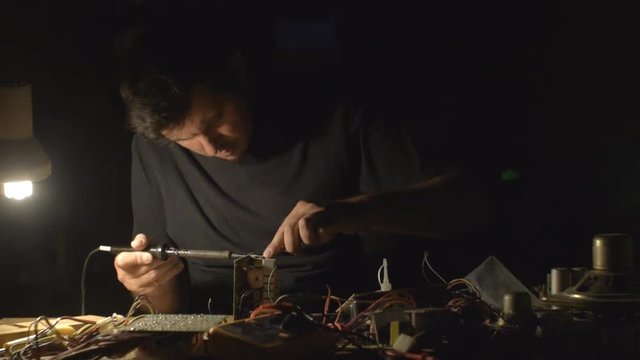 A young adult caucasian man technician working indoors