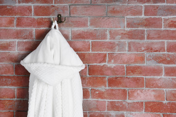 Bathrobe hanging on brick wall