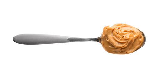 Creamy peanut butter in spoon on white background
