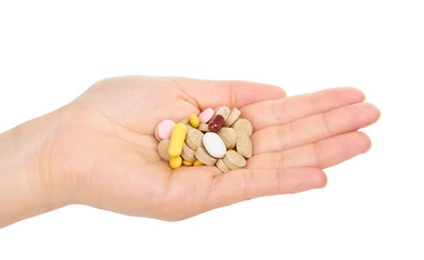 female hand holding pills. Isolated on white background