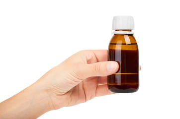 Syrup mixture in glass bottle in hand. Isolated on white background