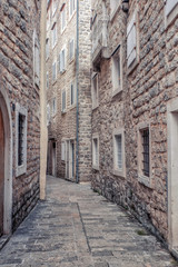 Fototapeta na wymiar View of picturesque narrow street with lattice windows on both sides