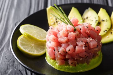 Foto op Plexiglas Tartare from tuna served with avocado, wasabi and lime macro. horizontal © FomaA
