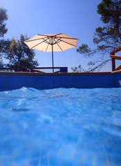 Swimming pool with parasol