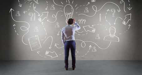 Businessman watching a project sketch on a wall 3D rendering